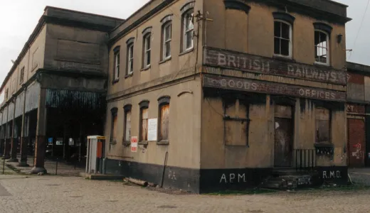 A derelict brick building and goods shed