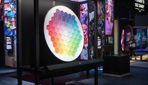 A colourful indoor exhibition space, with a large colour wheel 