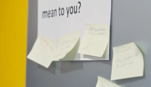 A sign reading 'what does curiosity mean to you?' with post-it notes around it