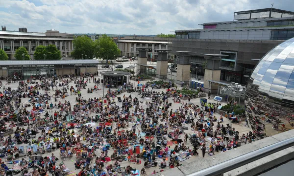 A large crowd of people gathered in Millennium Square