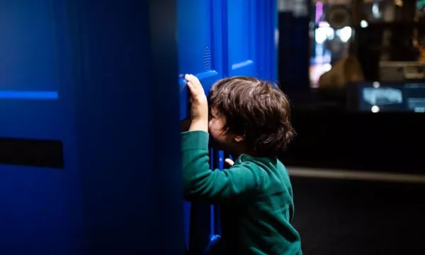 A child peering into the TARDIS