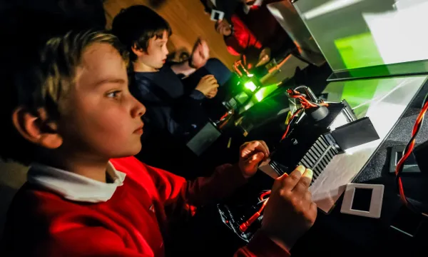 2 children looking at ray boxes on a table