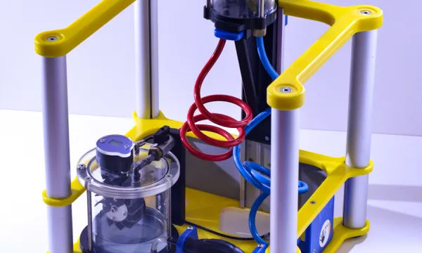 A portable exhibit with a pump connected to tanks of water via tubes