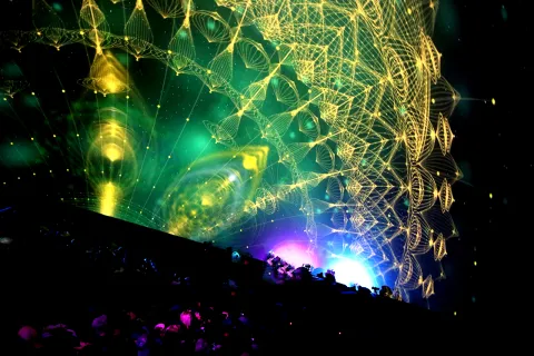 A big dome screen with abstract patterns projected onto it.