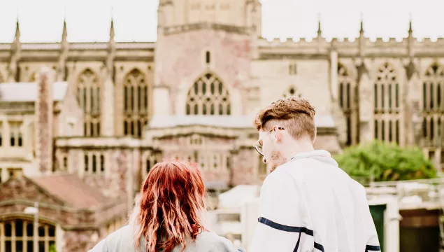 Two people enjoying the view from We The Curious roof top towards Bristol Cathedral