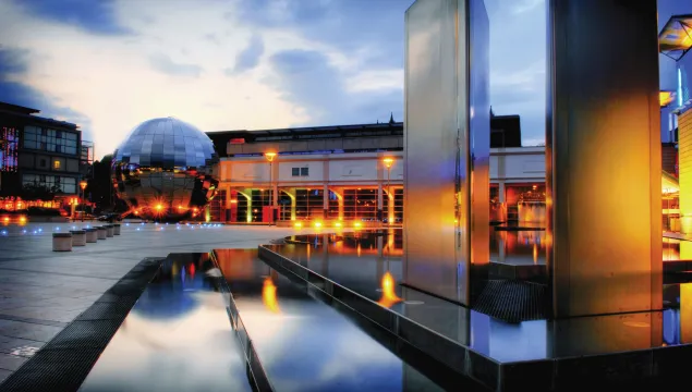 Millennium Square with water features and Planetarium beautifully lit up