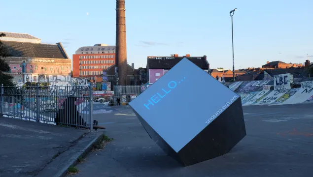 An interactive cube in an urban cityscape 