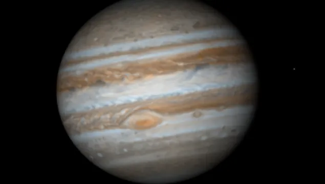 Photograph of Jupiter. Coloured bands of gas and the great red spot visible.
