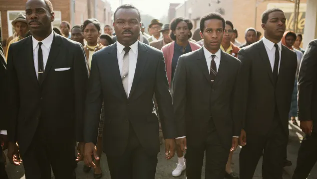 A promotional image for the film Selma with 4 men in suits walking towards the camera.