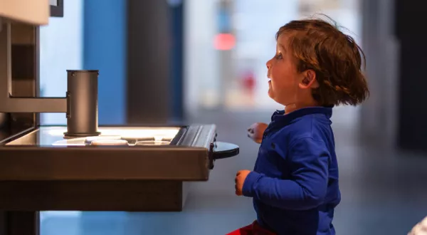 child sitting in front of a table