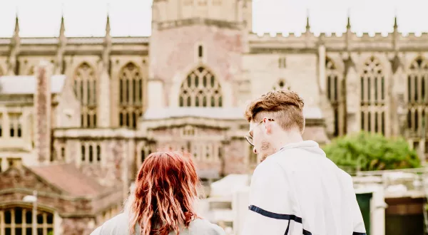 Two people enjoying the view from We The Curious roof top towards Bristol Cathedral