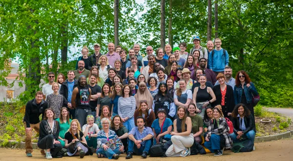 A large group of We The Curious staff posing for a photo outside