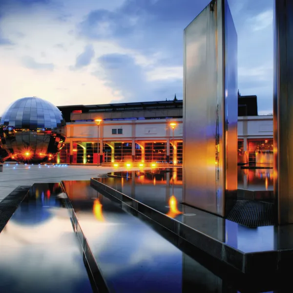 Millennium Square with water features and Planetarium beautifully lit up