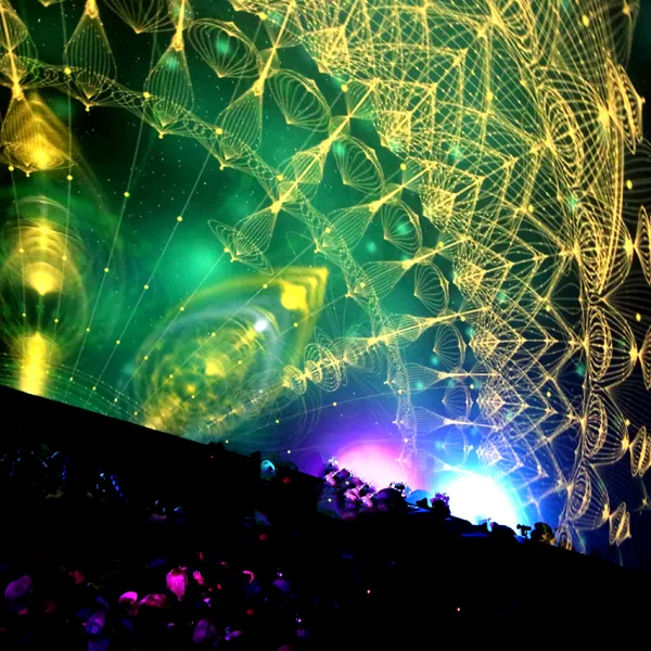 A big dome screen with abstract patterns projected onto it.