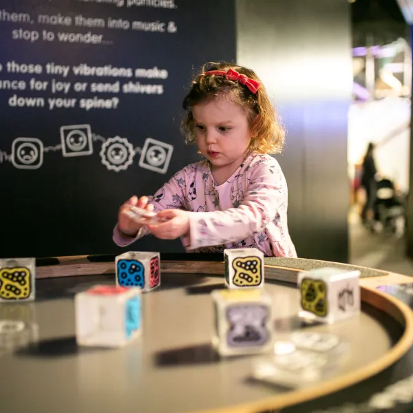 A small child plays with some cubes on top of an electric surface