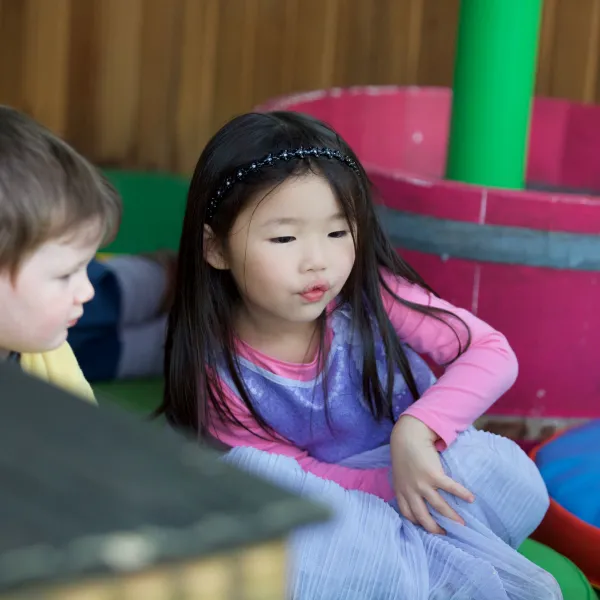 Two small children are playing in a science centre.