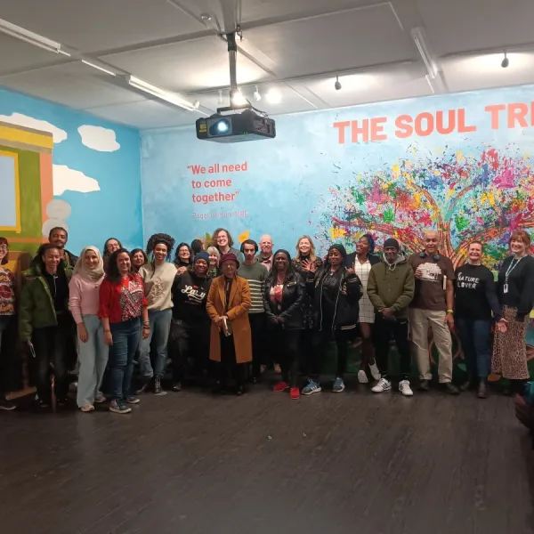 A large group of people stood in an indoor exhibition space